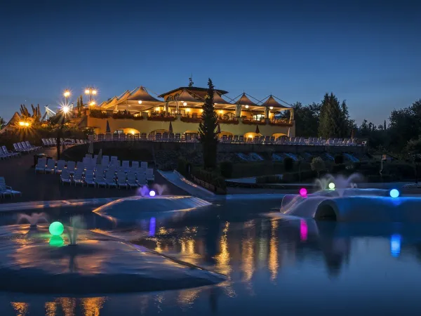 Lagune zwembad met uitzicht op restaurant bij Roan camping Norcenni Girasole.