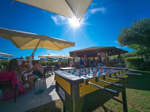 Tafelvoetbal en een terras bij Roan camping Rubicone.