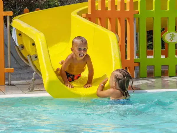 Kind glijd van leuke glijbaan op Roan camping Rubicone.